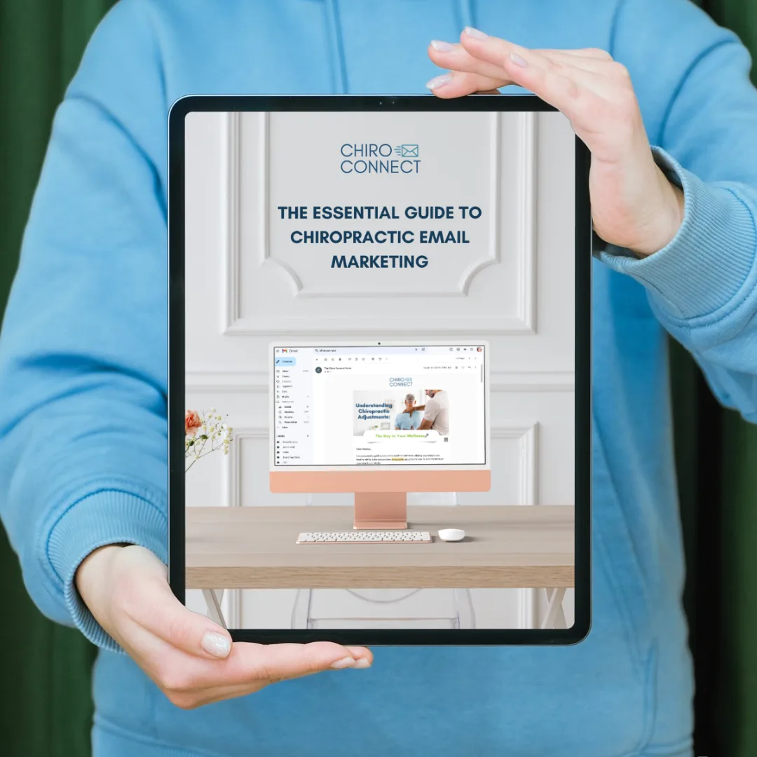A woman holding a tablet featuring the essential guide to chiropractic email marketing by chiro connect.