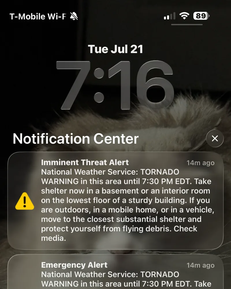iPhone lock screen showing a National Weather Service tornado warning at 7:16 PM